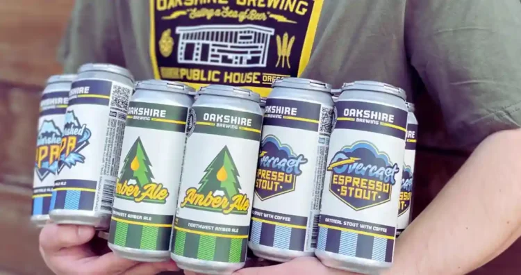 a person holding an armful of brightly colored beer cans