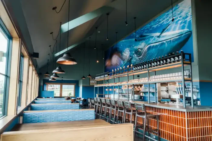 The interior of a pub, with a big, blue whale mural on one wall