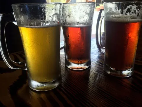 After the Taproom: A Responsible Wind-Down for Washington Beer Fans Three beer glasses on a wooden table.