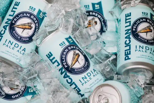 Cans of Pelican Lite IPA on ice.