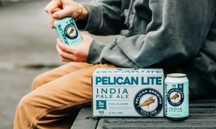 A person opening a can of Pelican Lite IPA