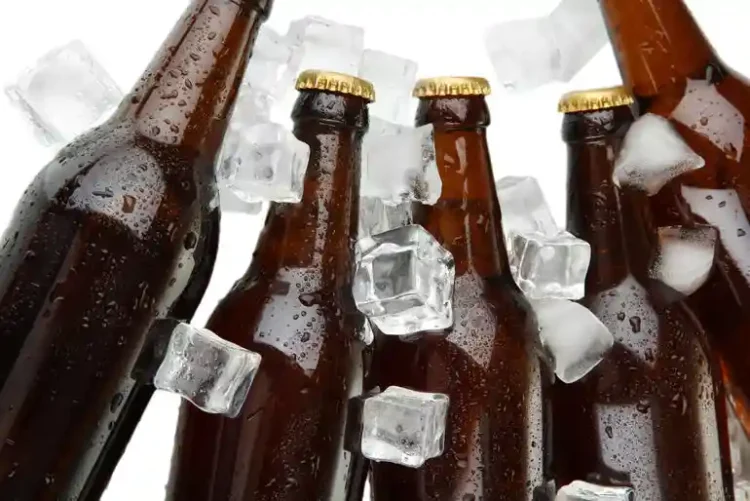Why Beer Can Taste So Much Better When It Is Cold Four bottles of beer on ice