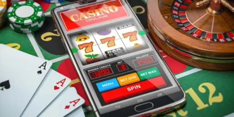 From Classic Reels to Modern Formats: The Evolution of the Best Online Slots An online slot game on a mobile phone with cards and poker chips nearby.