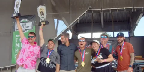 A group of people celebrate on stage after winning an award at GABF