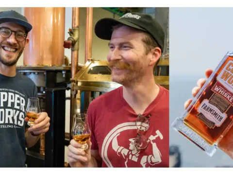 Two men sharing whiskey and hoisting a bottle