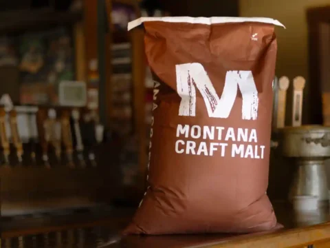Country Malt Group Announces New Partnership with Montana Craft Malt A bag of malted barley, brown with white letters