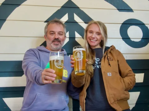 Grand Fir Brewing Opening Second Location in Damascus, Oregon Two people hoisting pints of beer