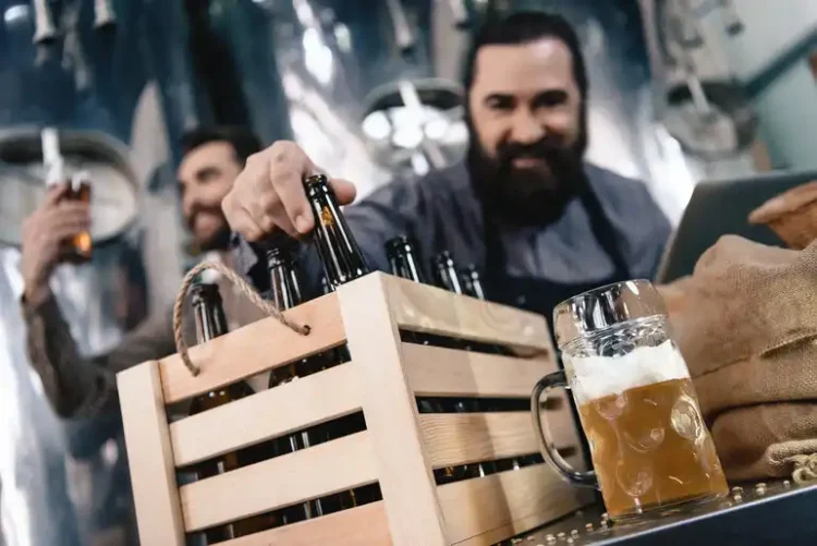 The New Taproom Downtime: What People Do While Waiting for the Next Pour Men selecting craft beer bottles in a brewery taproom with a freshly poured beer on the counter.