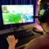 4 Useful Tips for Improving Your Online Gaming Skills Man playing a video game on a PC while improving his online gaming skills.